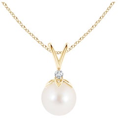Ciondolo a forma di balla di perle d'acqua dolce coltivate con diamante in oro giallo 14 carati