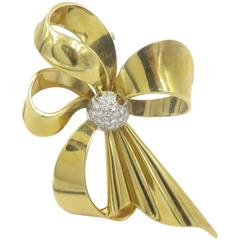 A Gold and Diamond Bow Brooch. A Gold and Diamond Bow Brooch.