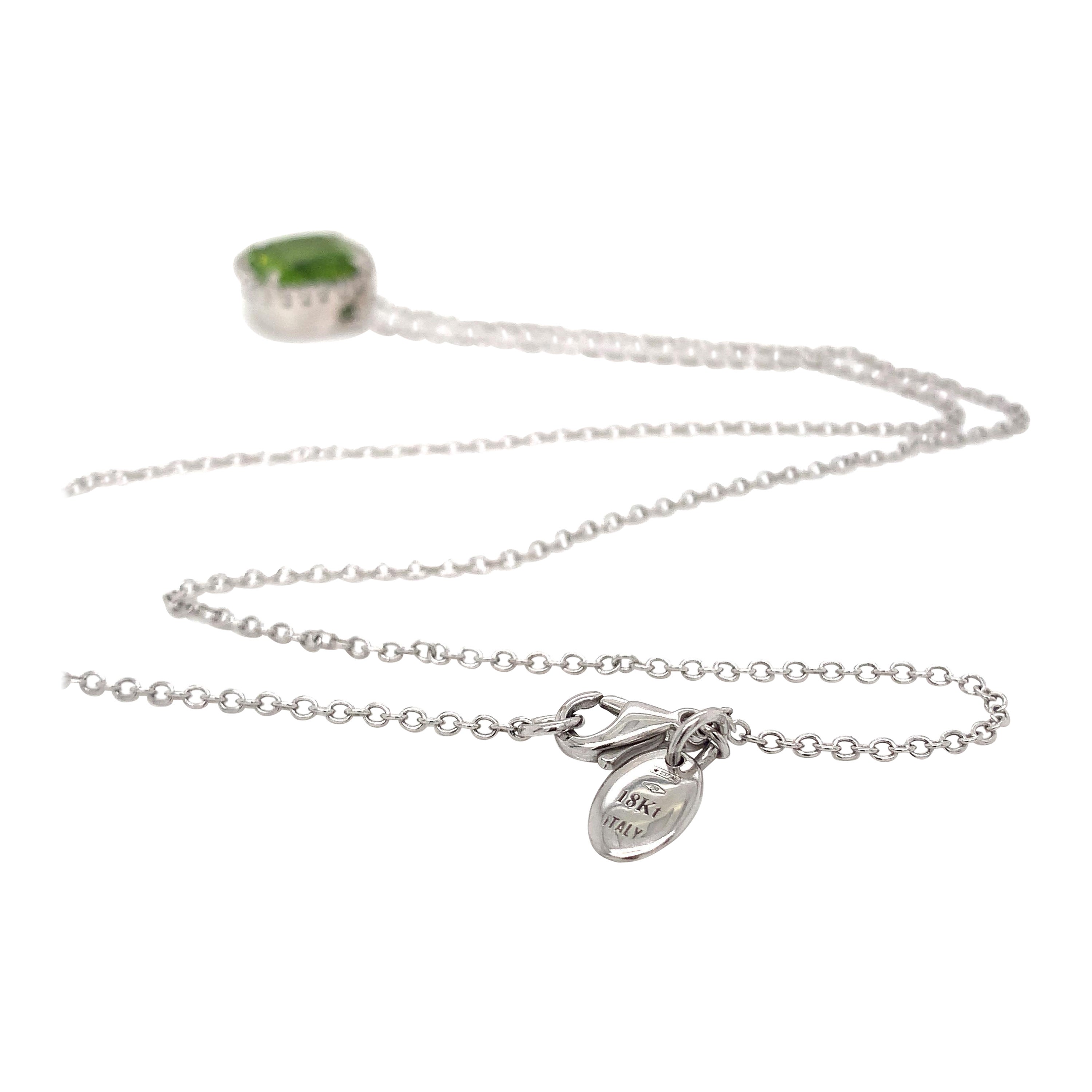 18KT White Gold Peridot and  Diamond Garavelli Pendant with Necklace 
GOLD gr : 6.4
DIAMOND ct : 0.10
Natural PERIDOT ct : 4.75
A green peridot  adorned with pave  diamonds is a dazzling combination of gemstones. The green peridot, with its vibrant