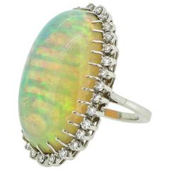 1960s-70s Modernist 47.05 Carat Cabochon Opal Ring with Diamond Halo