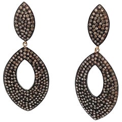 Boucles d'oreilles pendantes en rhodium noir avec diamants en champagne