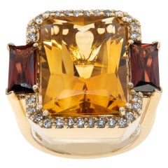 Carved ring in yellow gold with citrine, deep red garnet, and accent diamonds.