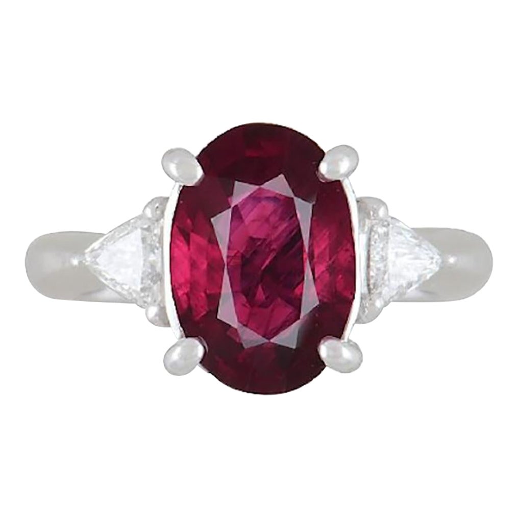GIA 3.19 Carat Oval Heated Burma Ruby & Diamond 3 Stone Ring in Platinum For Sale