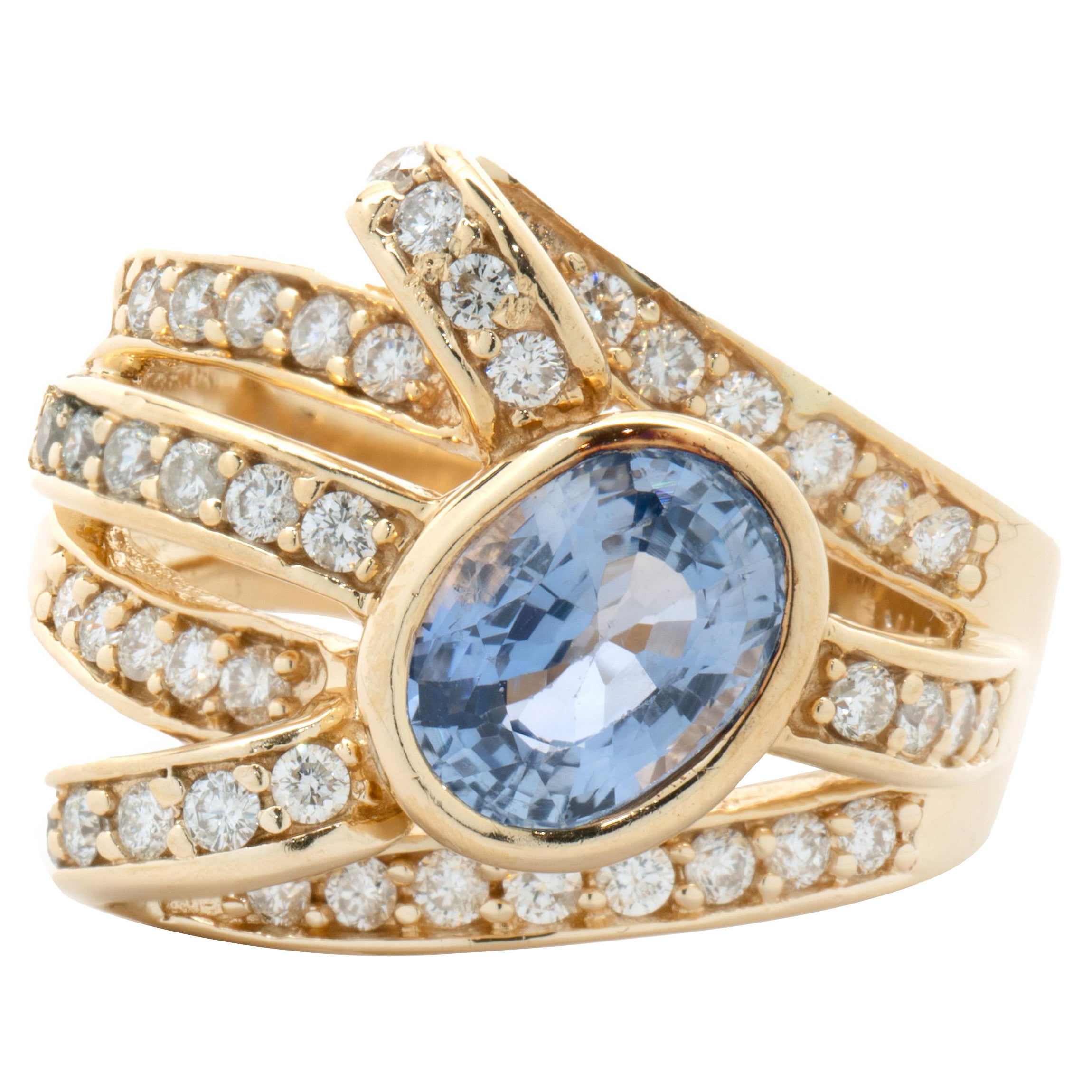 14 Karat Yellow Gold Bezel Set Cornflower Blue Sapphire and Diamond Bypass Ring For Sale