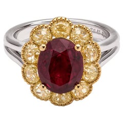 Stunning Burma oval ruby with fancy yellow diamonds