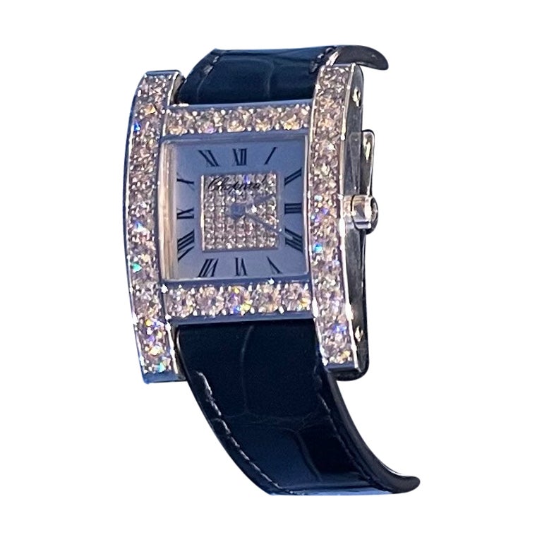 Exquisite, like brand new, ladies estate 18 karat white gold Chopard dress watch features a beautiful mother of pearl face, with Roman numerals and a pave diamond square shaped center piece, surrounded by an 