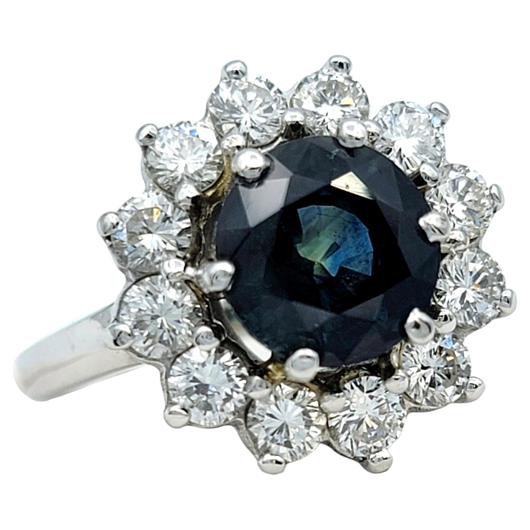 Round Blue Sapphire and Diamond Halo Flower Cocktail Ring in 14 Karat White Gold For Sale