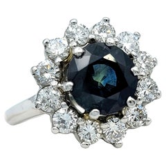 Round Blue Sapphire and Diamond Halo Flower Cocktail Ring in 14 Karat White Gold