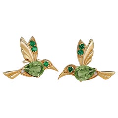 Used 14k Gold Hummingbird earrings studs with peridots. 