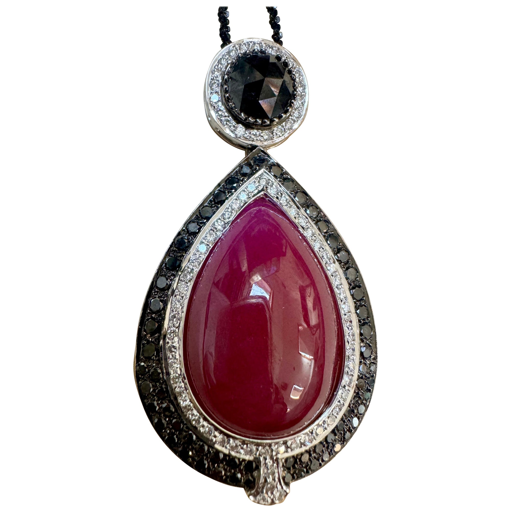 Vintage Large Pendant 40Ct Natural Ruby No Heat & Black & White Diamond 18KWG
This Large eye catching Pendant Necklace with is crafted from 18 Karat gold and features large Pear-shaped and a large Oval natural Rubies, totaling approximately 40