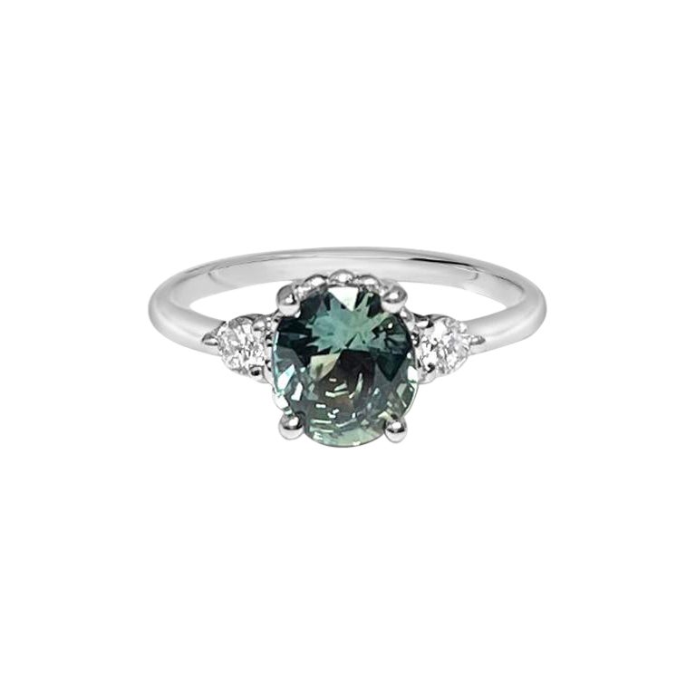 Engagement ring with oval green sapphire and diamonds