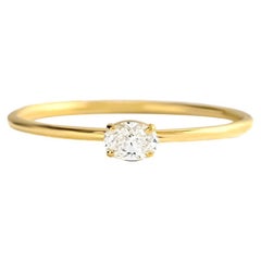 Tiny 14k gold ring with oval moissanite