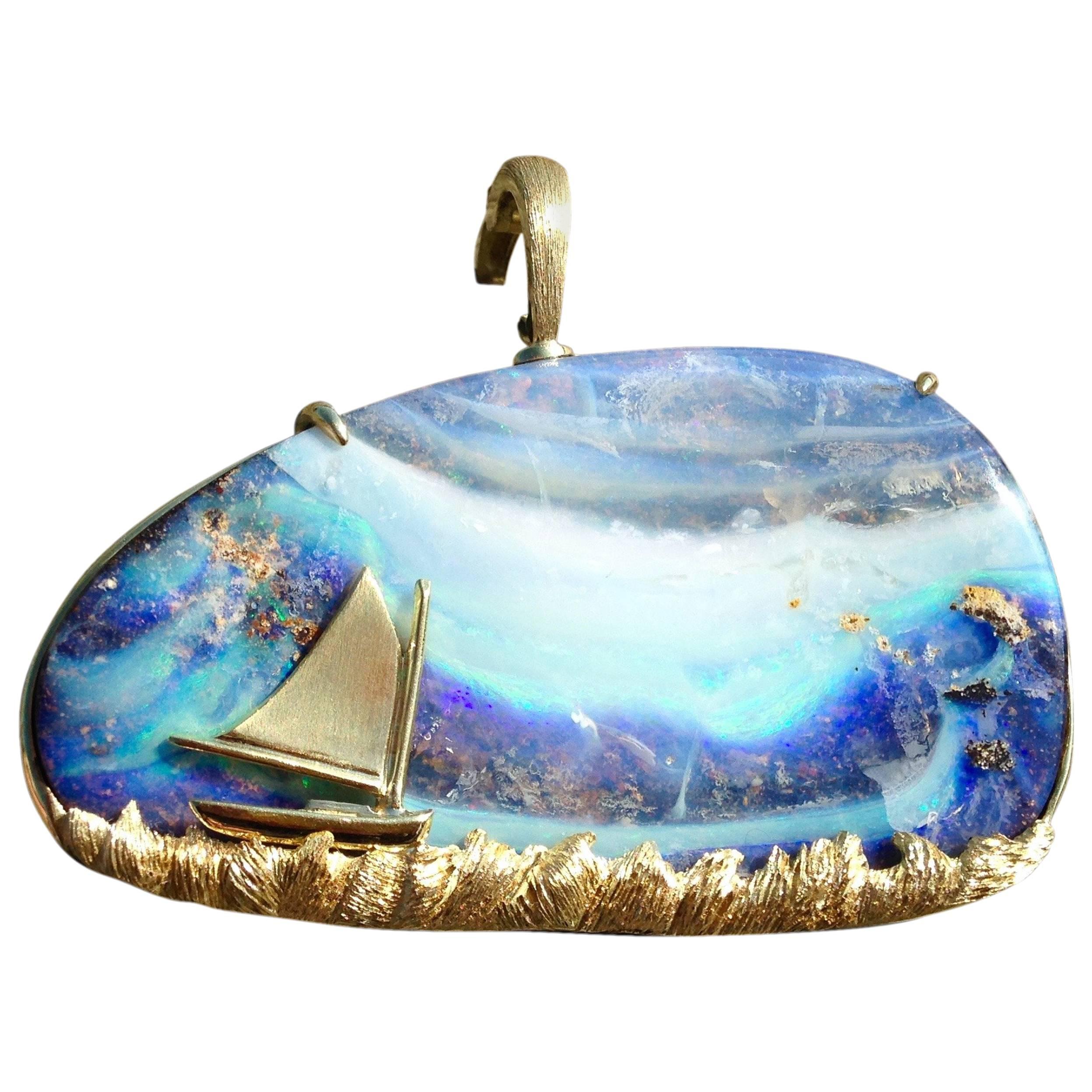 Creating a natural seascape, this Australian Boulder Opal pendant features 18kt Gold waves & an 18kt Gold catboat design. Securing tightly in the back, the 18kt Gold clasp is versatile when combined with chains of varying widths.

*Pendant is sold