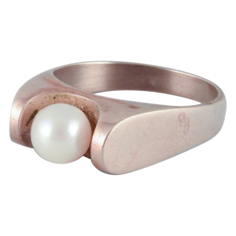 Danish goldsmith, 14 karat gold ring adorned with a cultured pearl. 