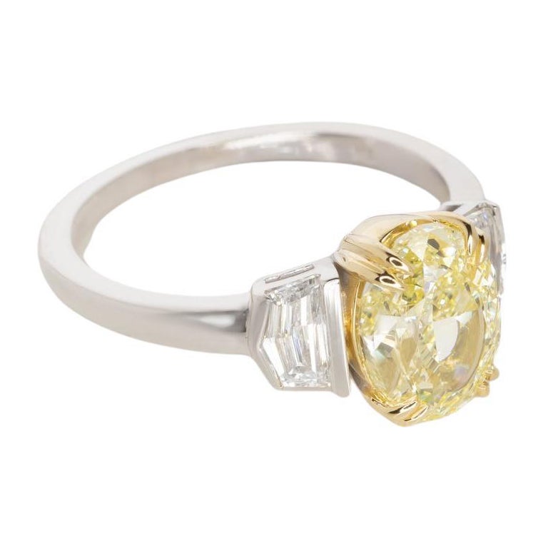 This ring, presented by Antinori di Sanpietro, showcases a radiant 2.00 carat oval brilliant diamond with a fancy yellow color and VS1 clarity, as certified by GIA. 

The diamond's hue is vibrant, and its cut allows for a striking dispersion of