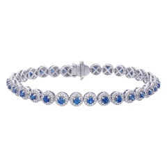 Bracelet tennis avec saphir bleu et halo de diamants tout autour 