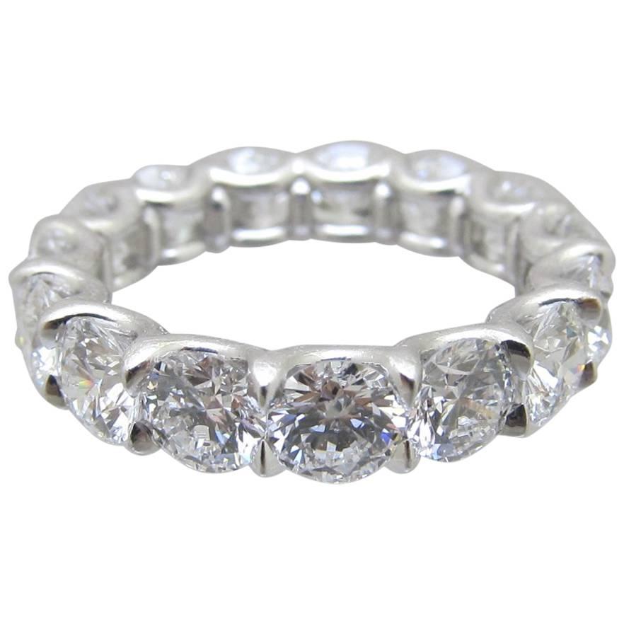Elegant diamond band with 15 brilliant shape diamonds set in platinum with common prong style & 