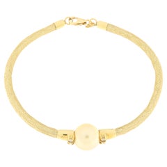 Yellow gold semirigid bracelet with diamonds and gold pearl