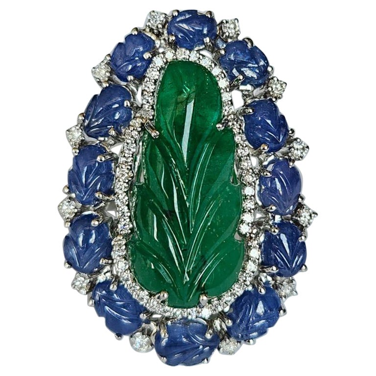 Set in 18K Gold, carved Zambian Emerald, Blue Sapphires & Diamonds Cocktail Ring For Sale