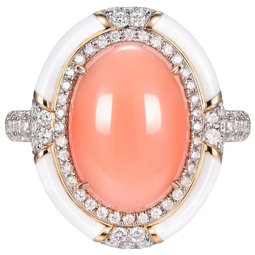 The Coral Diamond Enamel Ring, beautifully set in 14 Karat Yellow Gold, epitomizes the fusion of nature's grandeur with impeccable human artistry. At its heart lies a magnificent coral gemstone, weighing a substantial 6.75 carats. This coral exudes