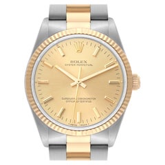 Rolex Montre Oyster Perpetual à lunette cannelée en acier et or jaune pour hommes 14233