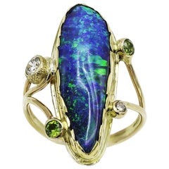 Large Boulder Opal Ring with Green Garnets and White Sapphires Set in Gold