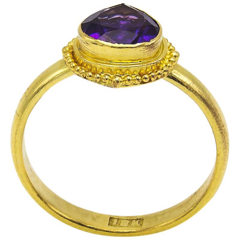 This beautiful and artistic pear-shaped amethyst ring is set in a 18K yellow gold bezel with intricacy that is absolutely gorgeous. The bright purple amethyst is juicy and the entire piece is stunning! Amethyst is the birth stone for February. 