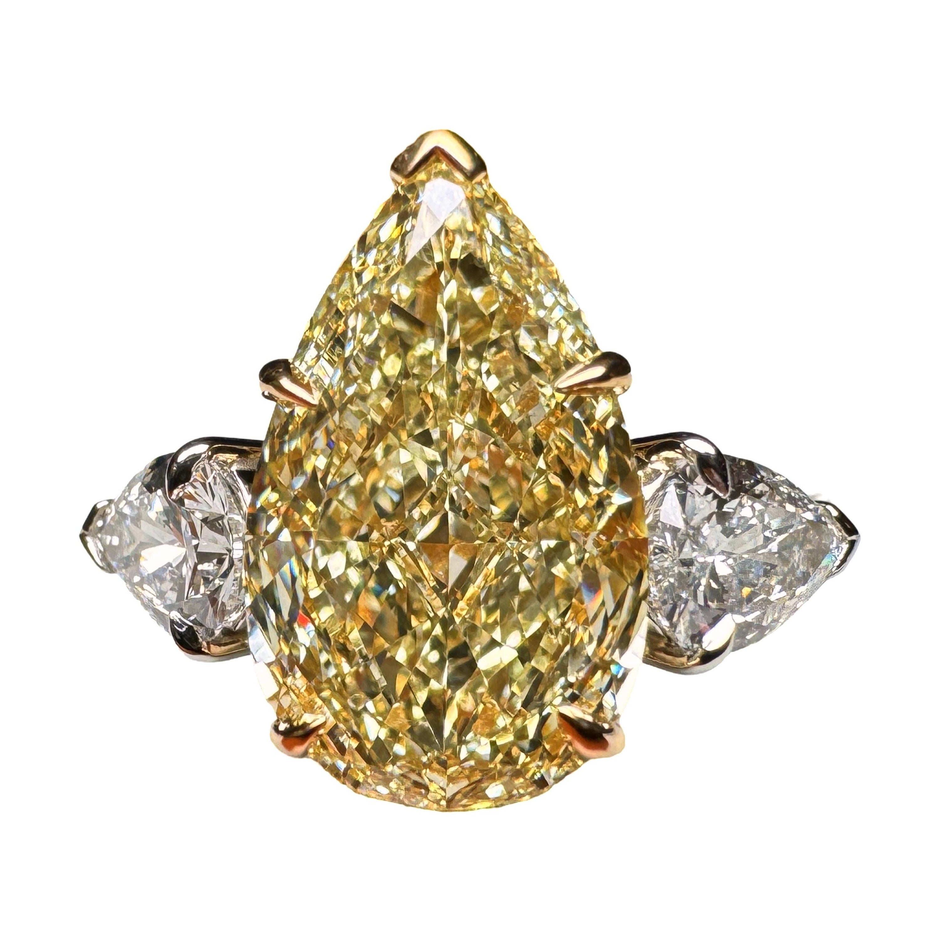 GIA Certified 4.01 Carat Pear Cut Yellow Diamond 3 Stone Ring For Sale