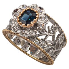 Anillo de oro amarillo estilo art déco con diamante blanco talla esmeralda y zafiro azul