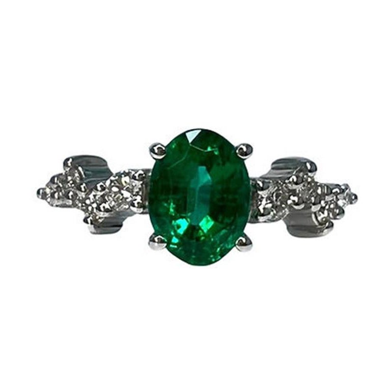 1.3 Carat Emerald Oval Cluster Ring For Sale