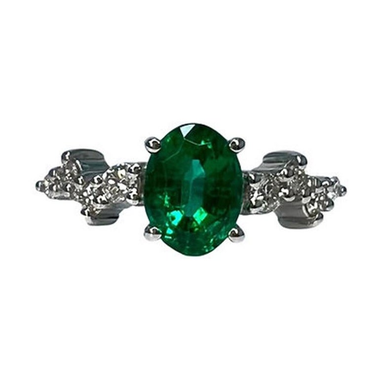 1.3 Carat Emerald Oval Cluster Ring For Sale