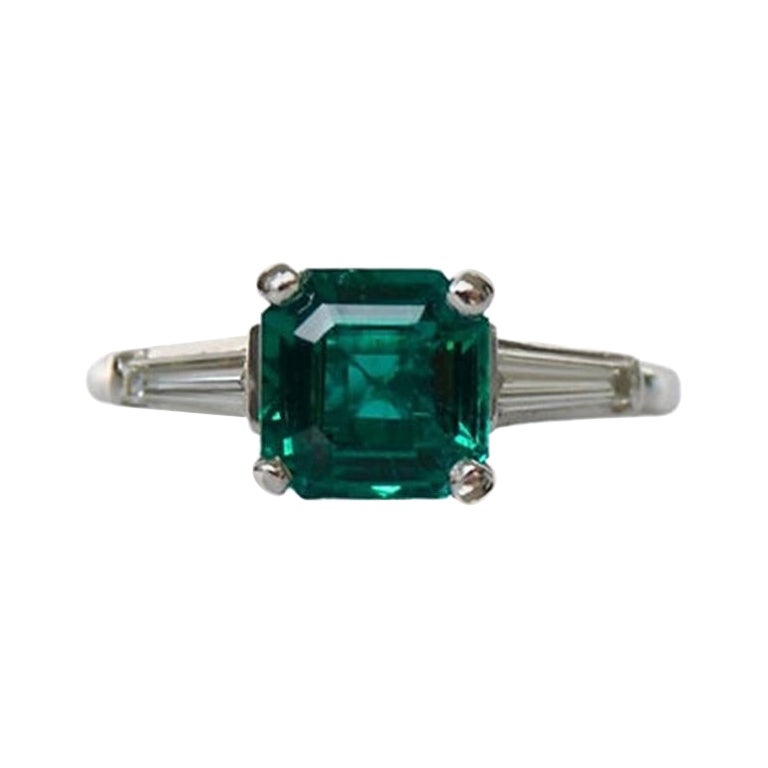 1.67 Carat Emerald EC Three Stone Ring For Sale