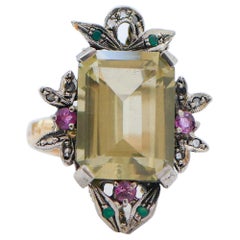 Bague en or rose, émeraudes, rubis, diamants et topaze