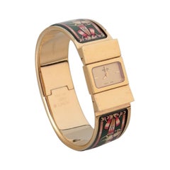 Hermes, montre-bracelet pour dames. Fabriquée en métal doré et en émail. 
