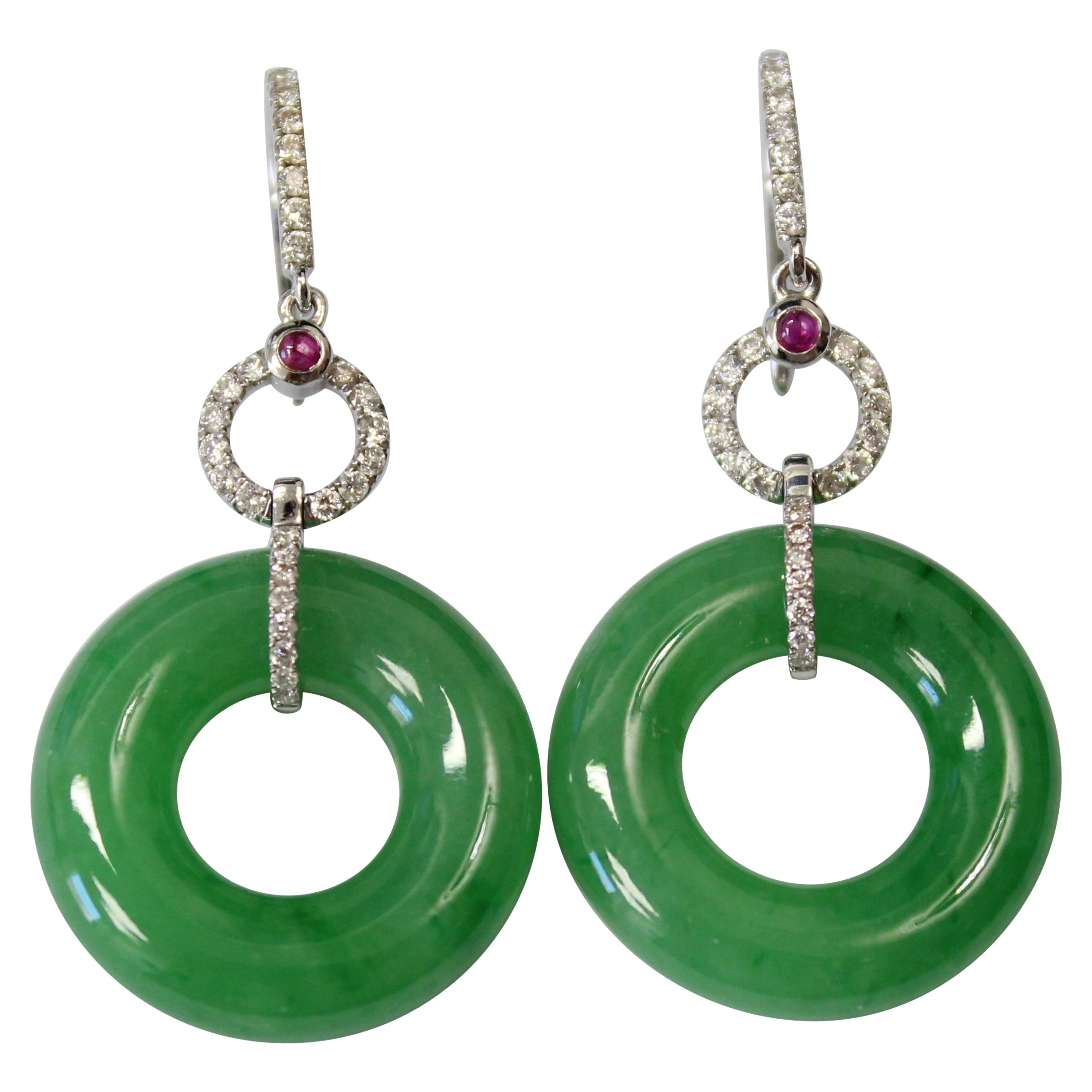 Each suspending a translucent jadeite hoop of bright green color, the white gold interlocking loops of the earring are set with brilliant-cut diamonds and rubies. 

Dimensions & Weight

jade loop diameter: 21mm; jade thickness: 5mm 

total height of