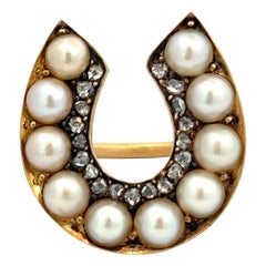 Anillo herradura de perlas y diamantes