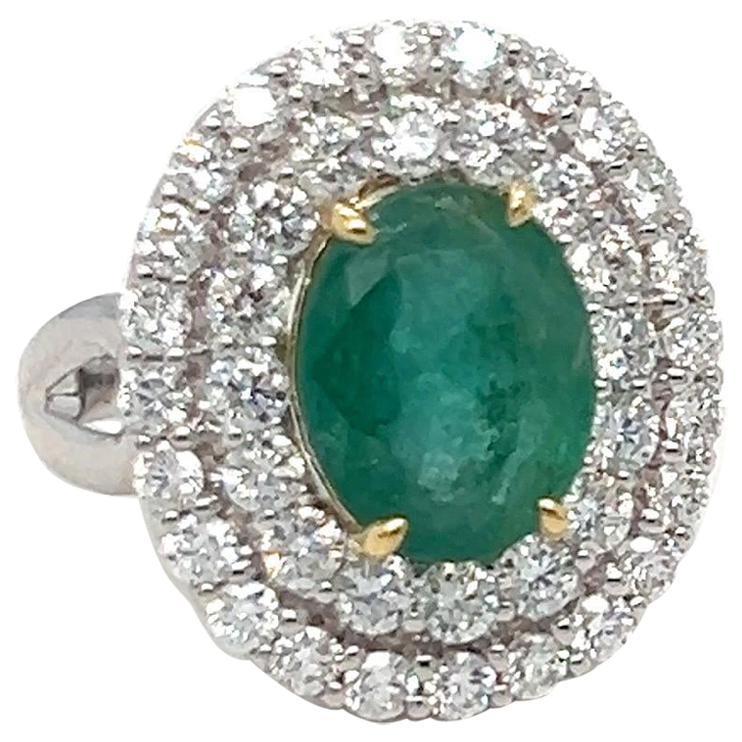 1.65 Carat Oval Cut Emerald and Diamond Halo Ring For Sale