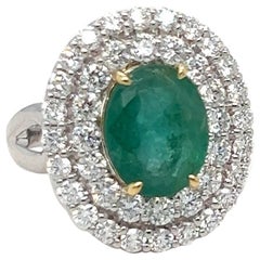 1.65 Carat Oval Cut Emerald and Diamond Halo Ring