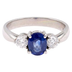 Anello a tre pietre in platino con zaffiro blu ovale