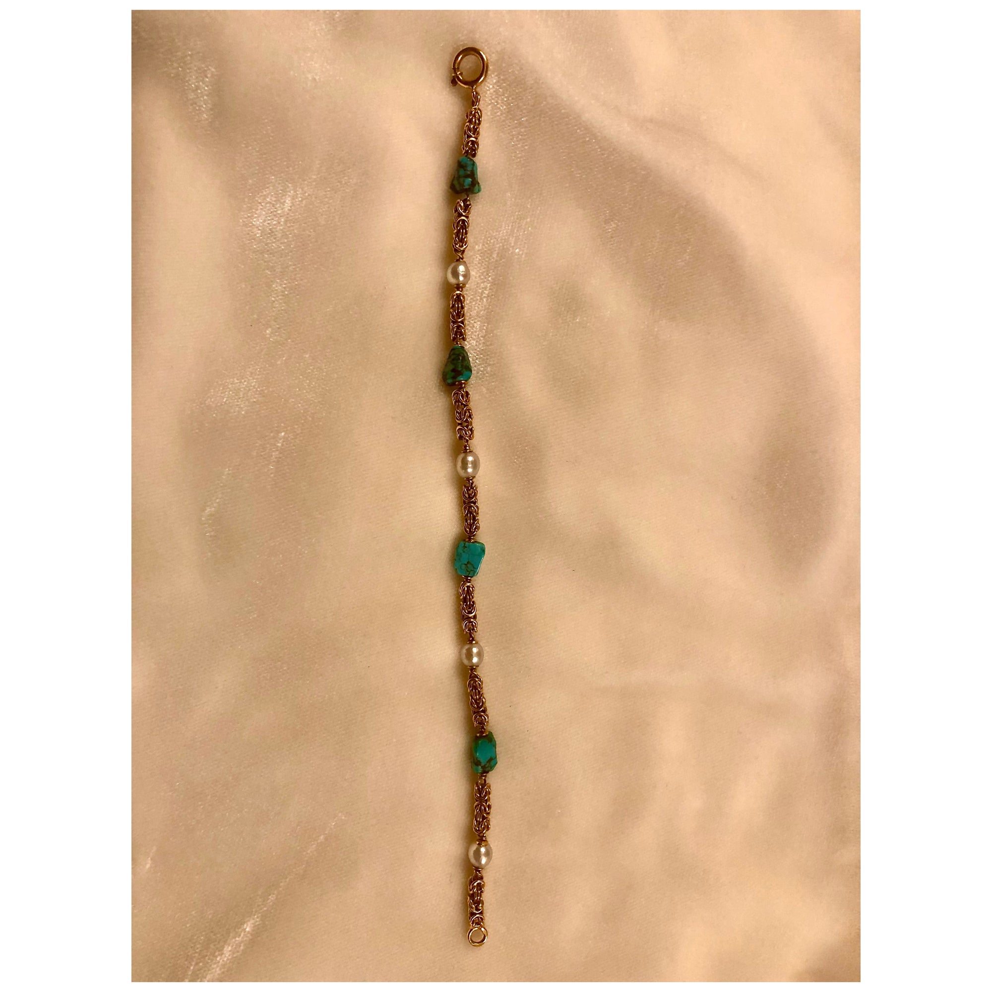 Very pretty and extremely well-made delicate bracelet with richly colored turquoise with black matrix. The pearls, while small, are extremely lustrous and virtually blemish free.

The chain is beautifully wrought in a Byzantine style of 19kt gold