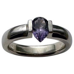 An 18kt White Gold Tension Ring holding a Purple Pear Shaped Spinel of 1.1 Carat