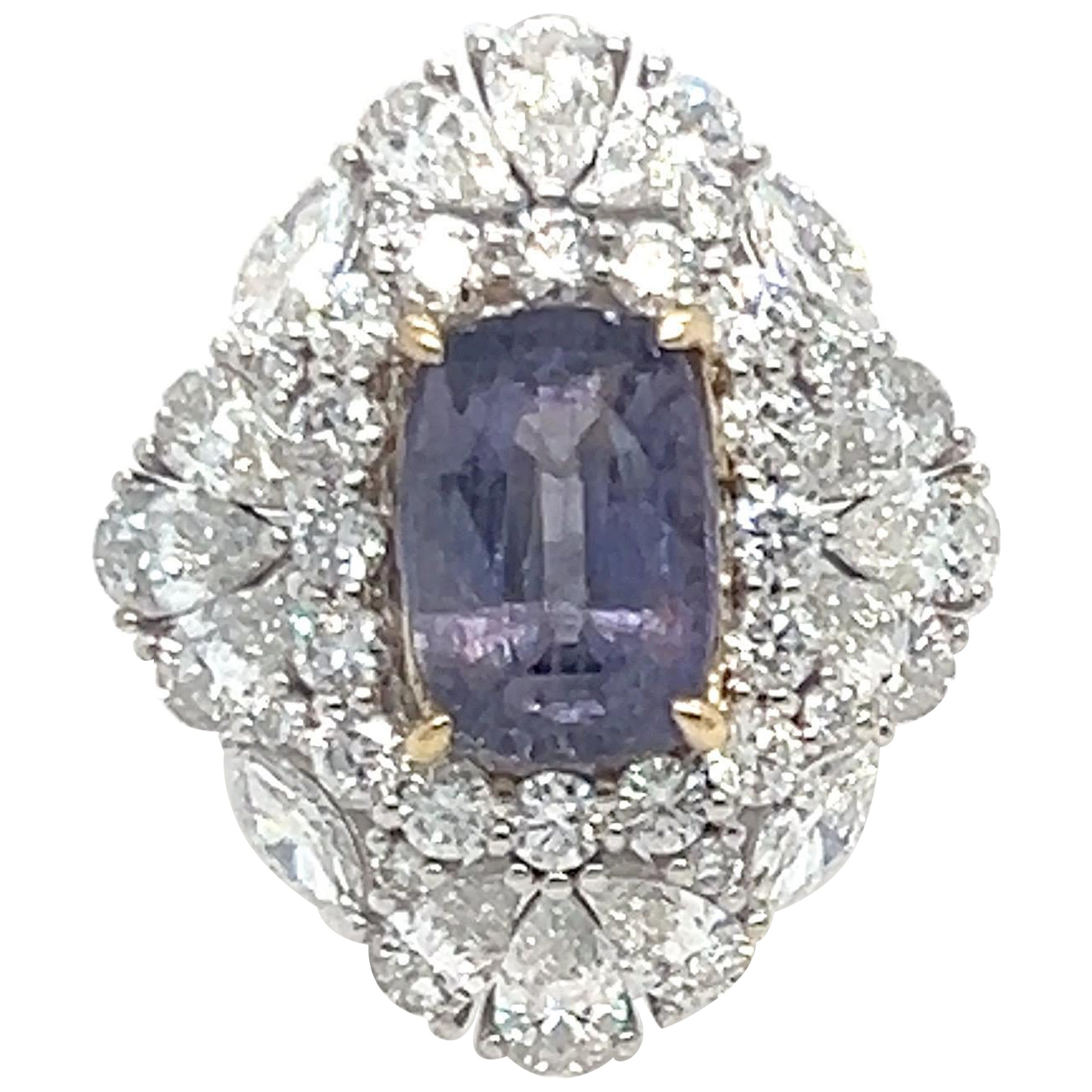 This exquisite ring features a GIA-certified, no-heat 3.66-carat purple sapphire, surrounded by 2.81 carats of mixed-cut diamonds. The diamonds have a clarity of VS and a color grade of F. Set in elegant 18k white gold, the design is enhanced with a