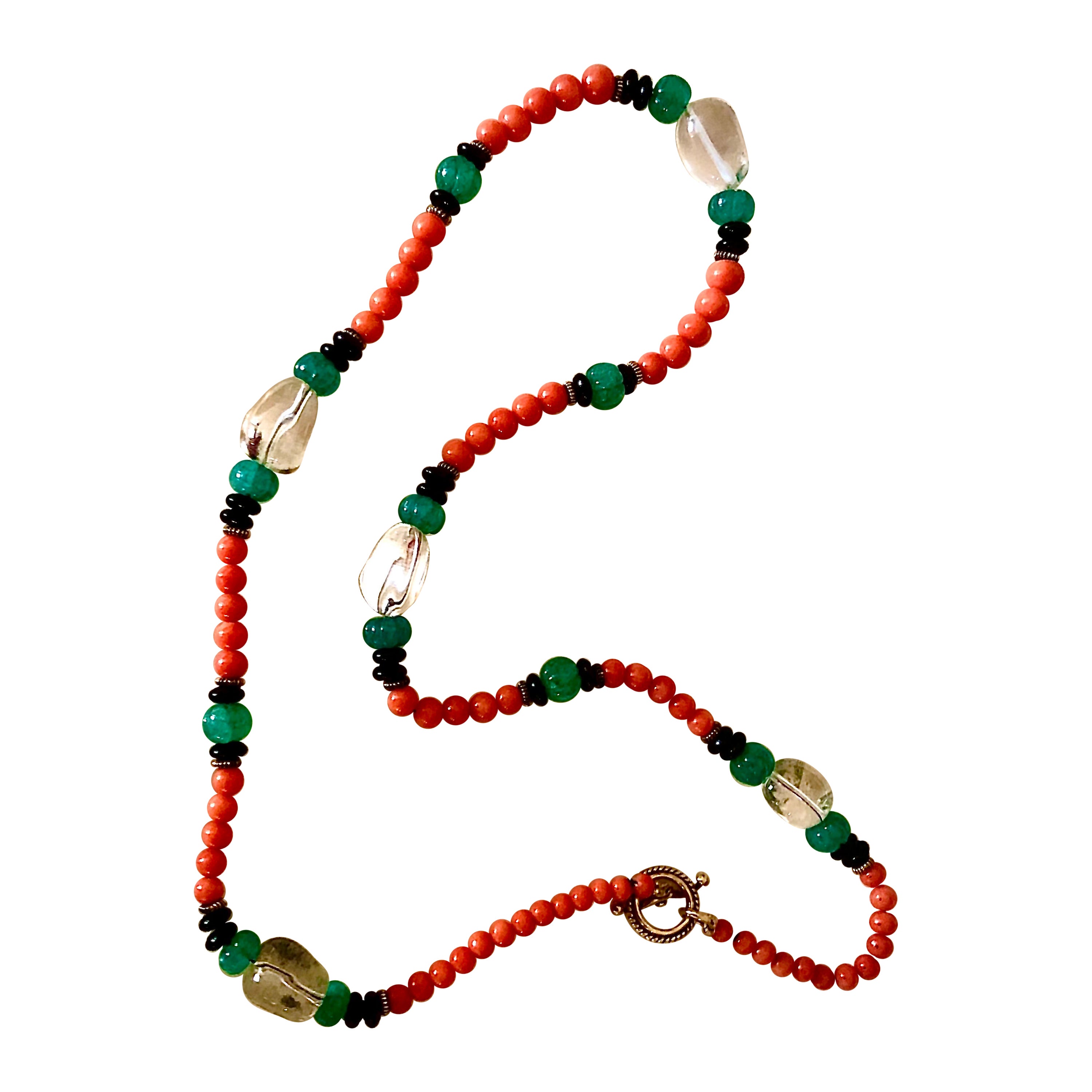 Collana in corallo, cristallo di rocca, smeraldi intagliati, onice nera e vermeil