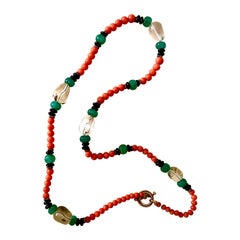 Coral, rock crystal, carved emeralds, black onyx and vermeil necklace