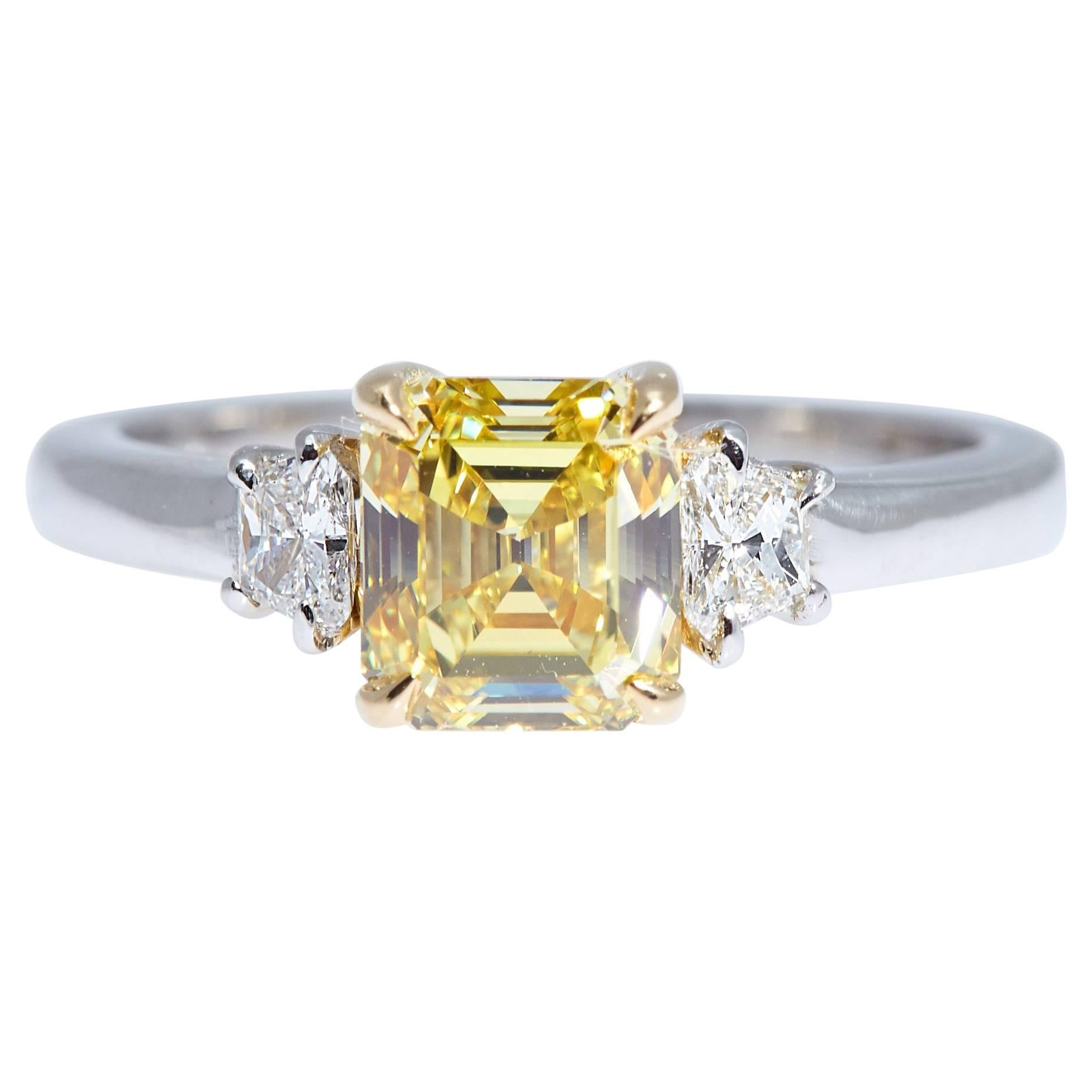 GIA Intense Yellow 1.62 Carat Emerald Cut Diamond Platinum Three-Stone Ring For Sale