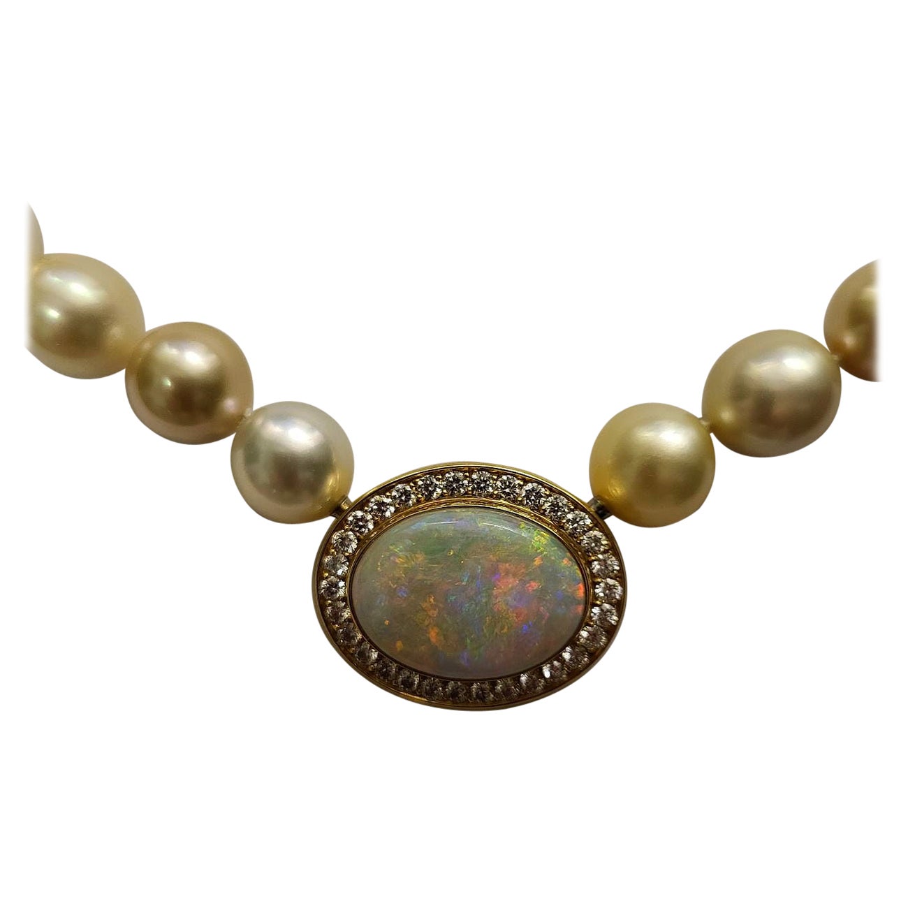 This mesmerizing, Australian opal pendant is handmade in solid 18k yellow gold and surrounded by high-class natural brilliant-cut diamonds.
The large white crystal Opal weighs in at 13 ct, with a truly superb play of color. 
The measurements of the