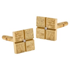 Elegant gold cufflinks with diamonds.