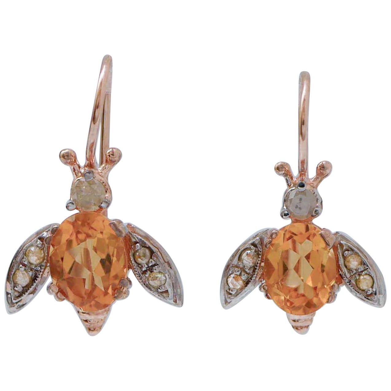 Ohrringe in Fliegenform mit Topas, Diamanten, Roségold und Silber.