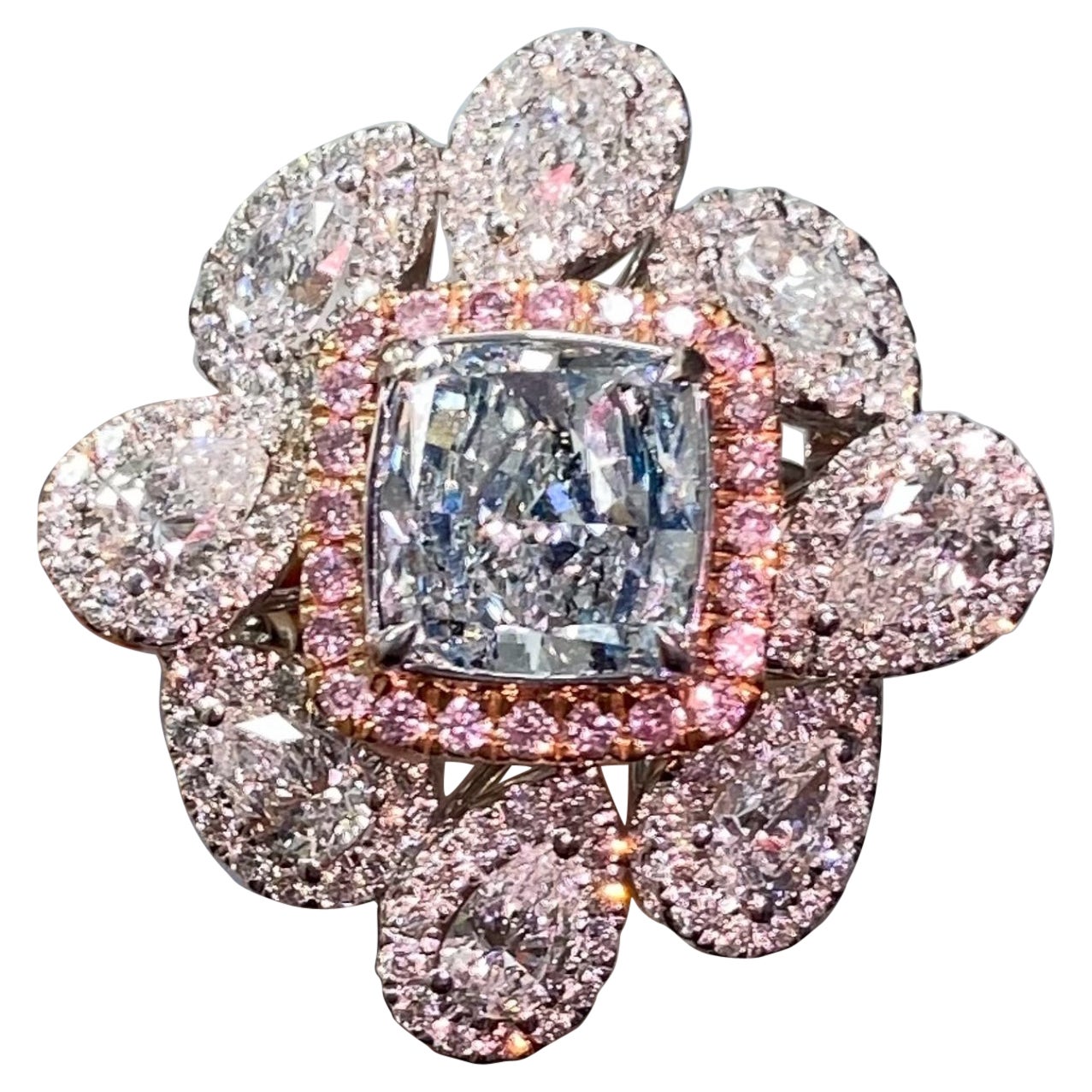 1.67 Carat Center Cushion cut  Fancy Light Bluish Green diamond SI1 Clarity
Set with 2.01 Carats surrounding white diamonds  and 0.18 Carats of surrounding pink diamonds
GIA Certified Blue Diamond
Crafted in 18k White Gold

At Rare Colors, you can