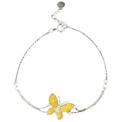 Bracciale a farfalla con diamanti gialli e diamanti in oro bianco 18 carati